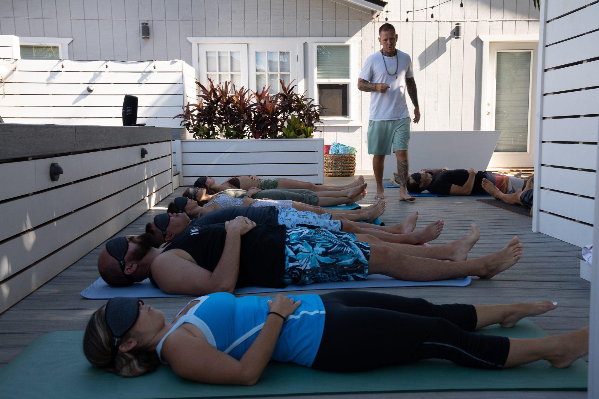 Practitioners lying with eye masks during a guided breathwork journey