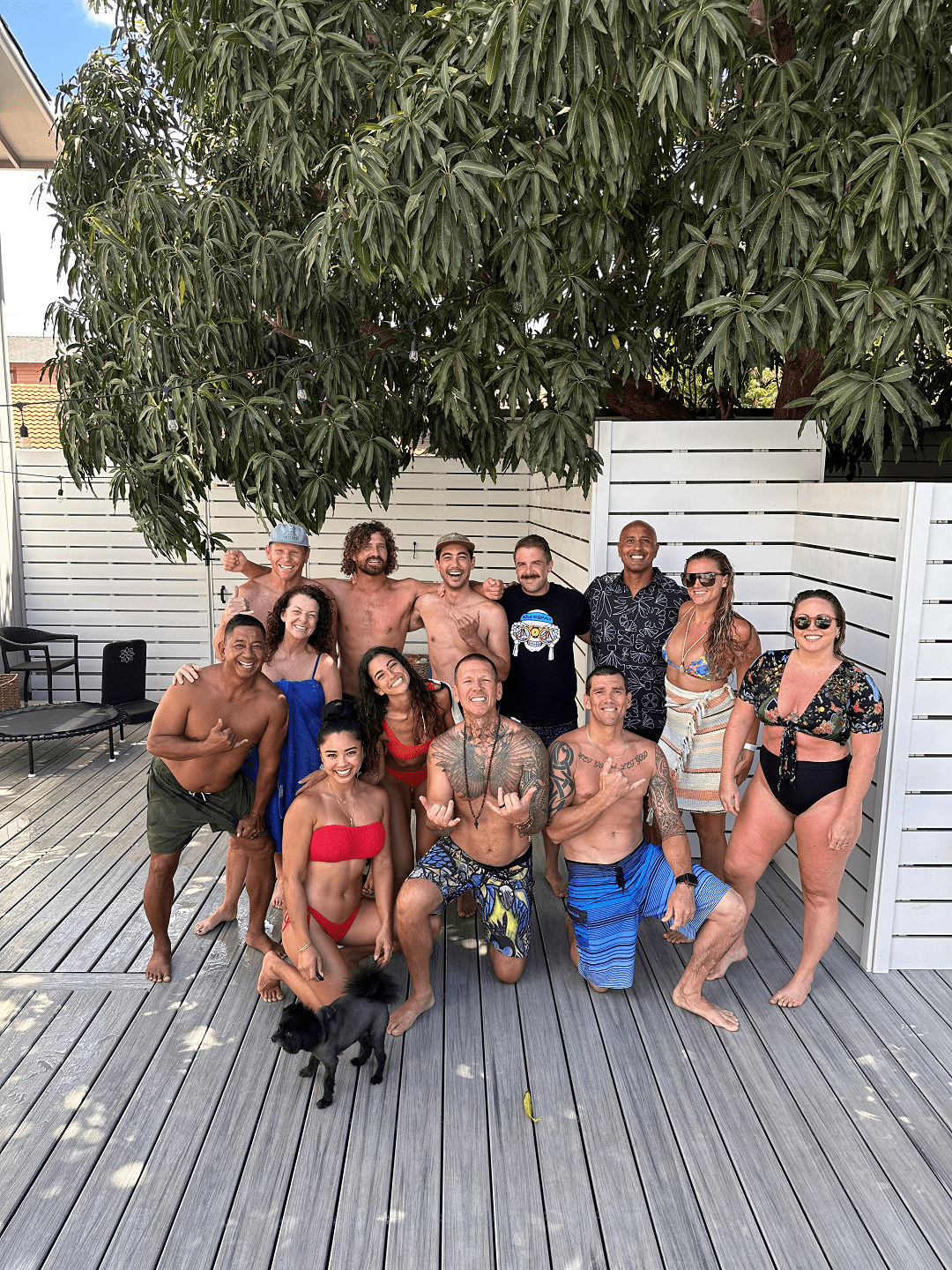 A retreat group gathered under the mango tree on the Maui deck