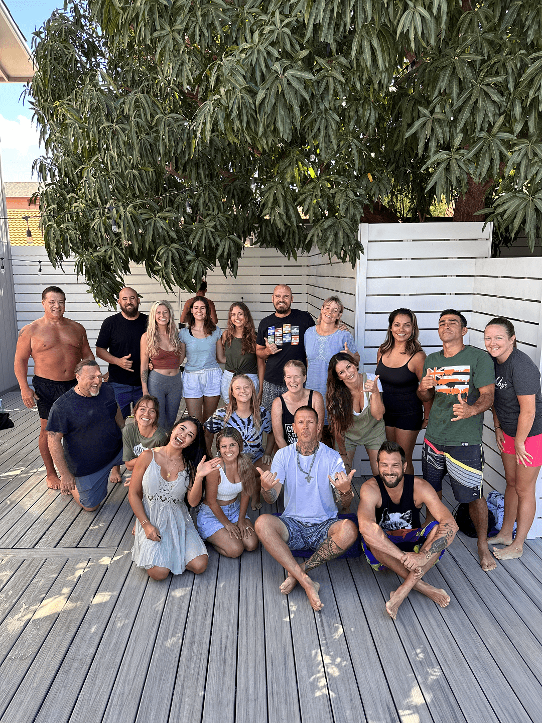 A breathwork journey gathered under the string lights on the Maui deck