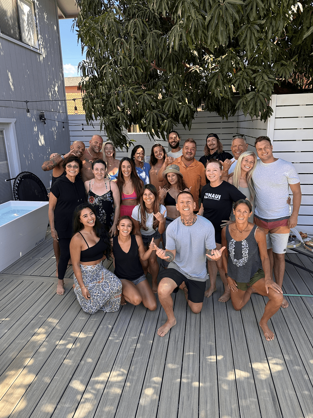 A retreat cohort gathered on the Maui deck