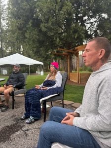 A facilitator leading a seated session at the Oregon retreat