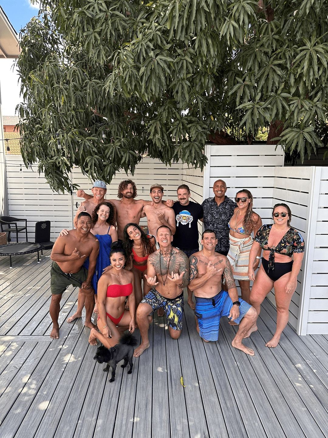 A retreat group gathered under the mango tree on the Maui deck